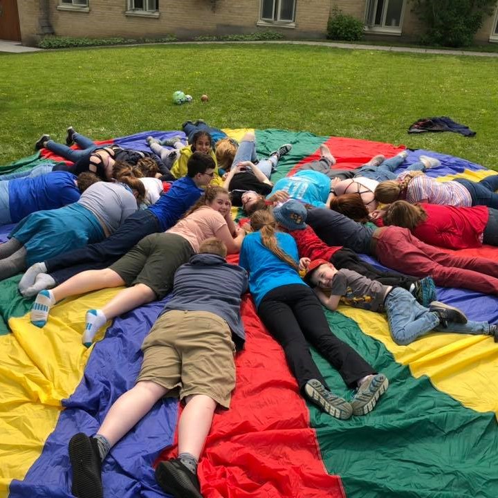 Youth lying on a parachute